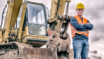 Man standing by equipment Man standing by equipment