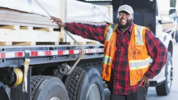 Man standing by truck Man standing by truck